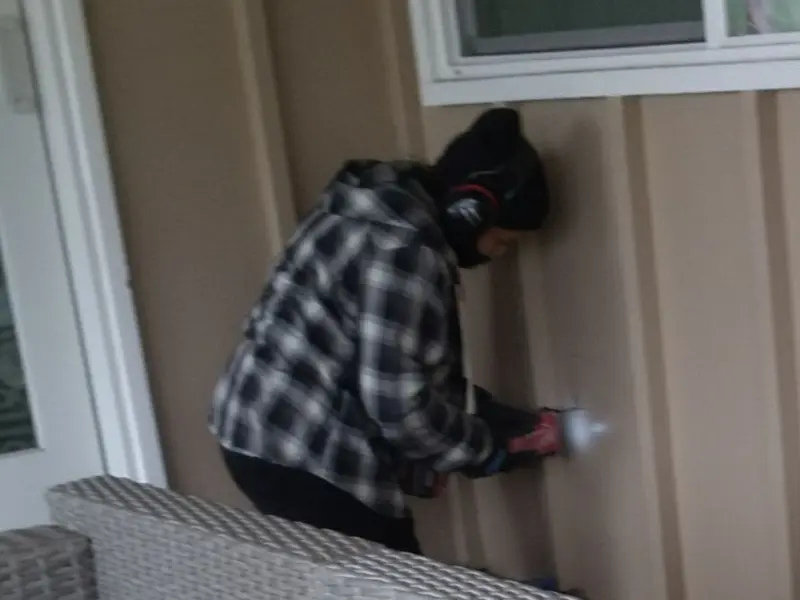 Professional electrician installing an exterior outlet in Woolwich